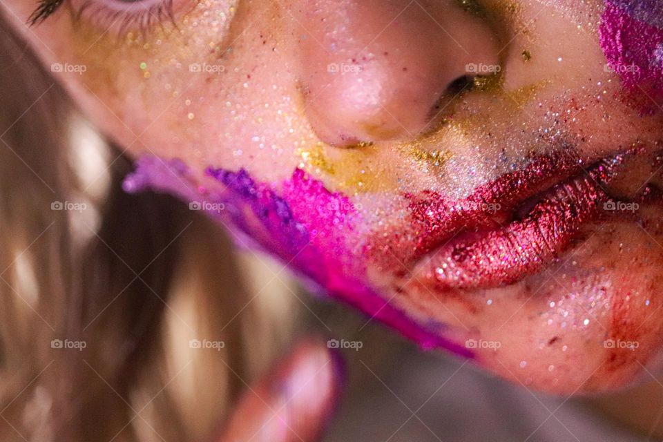 A child wearing glitter makeup