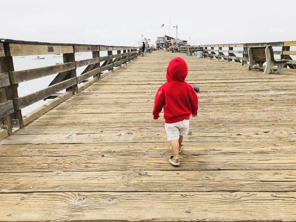 Red hood walking on the wharf 