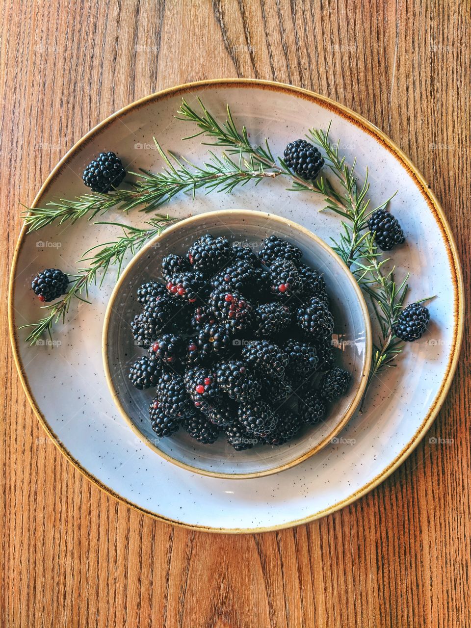 Background of fresh ripe blackberry on white plate close up. Top view. Flat laу.