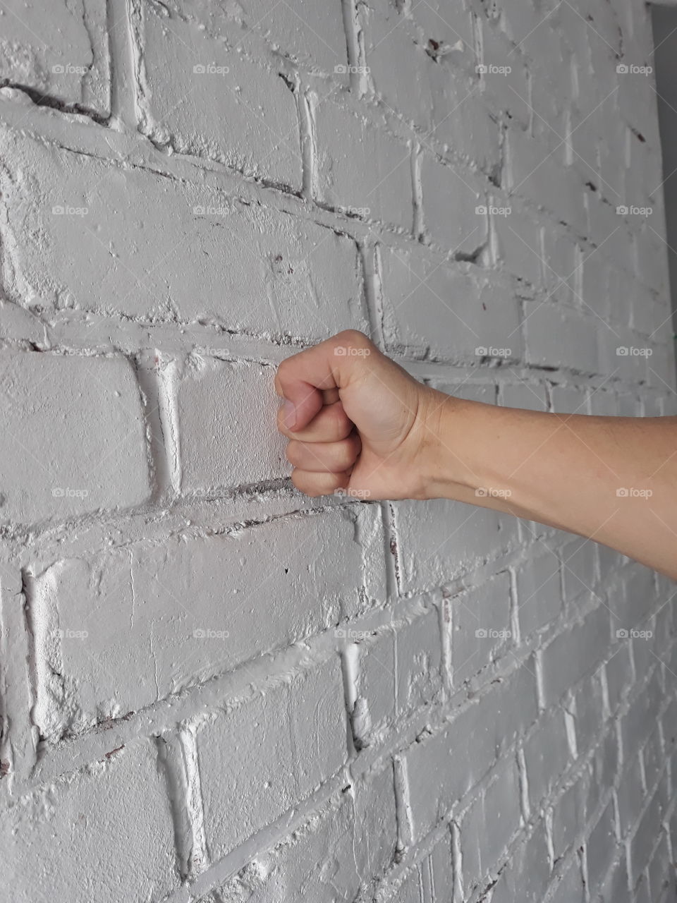 fist on a brick wall