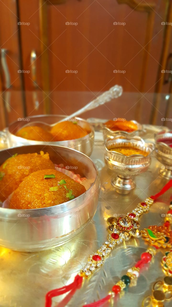 #rakhee #tradition #indiantradition #sweet #delicious #orangesweet #silver #silverbowl #luxury #food #indoor