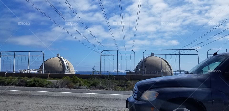 Nuclear power plant along a freeway in Southern California, with car.
