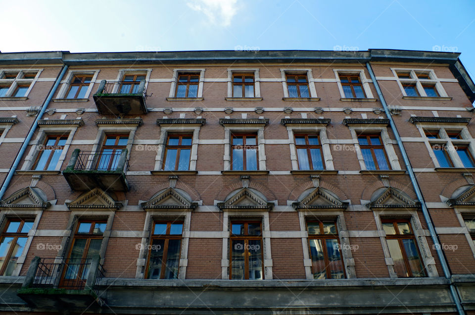 Low angle view of building exterior against sky in Kraków, Poland.