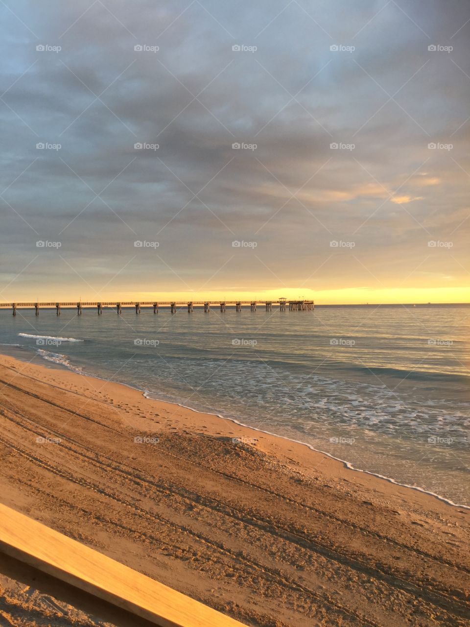 Sunrise on the beach looking at the pier 