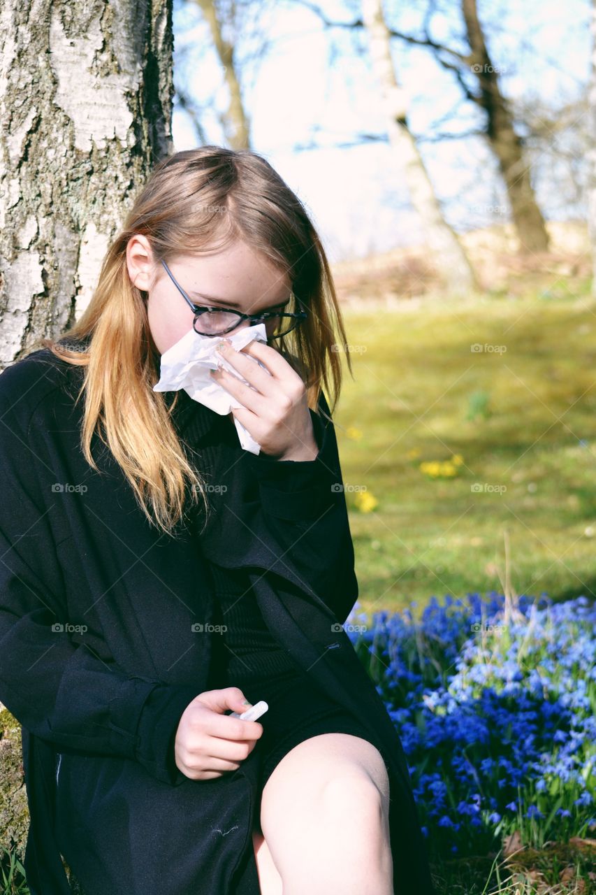 Close-up of a woman blowing her nose