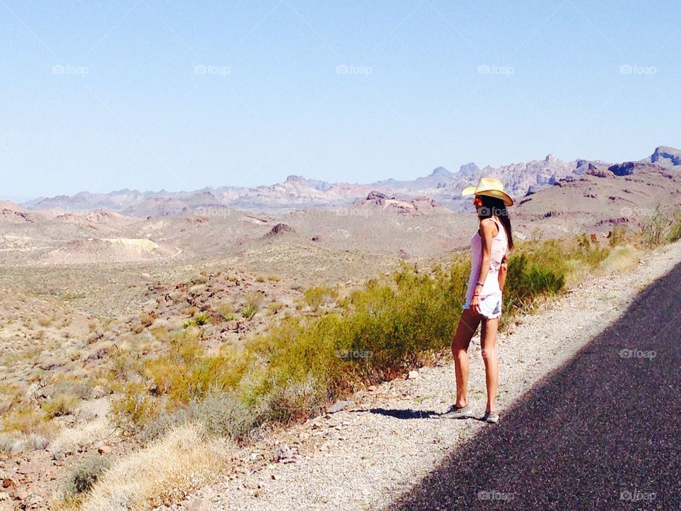 A woman look the desert from the route 66 near Oatman,Arizona