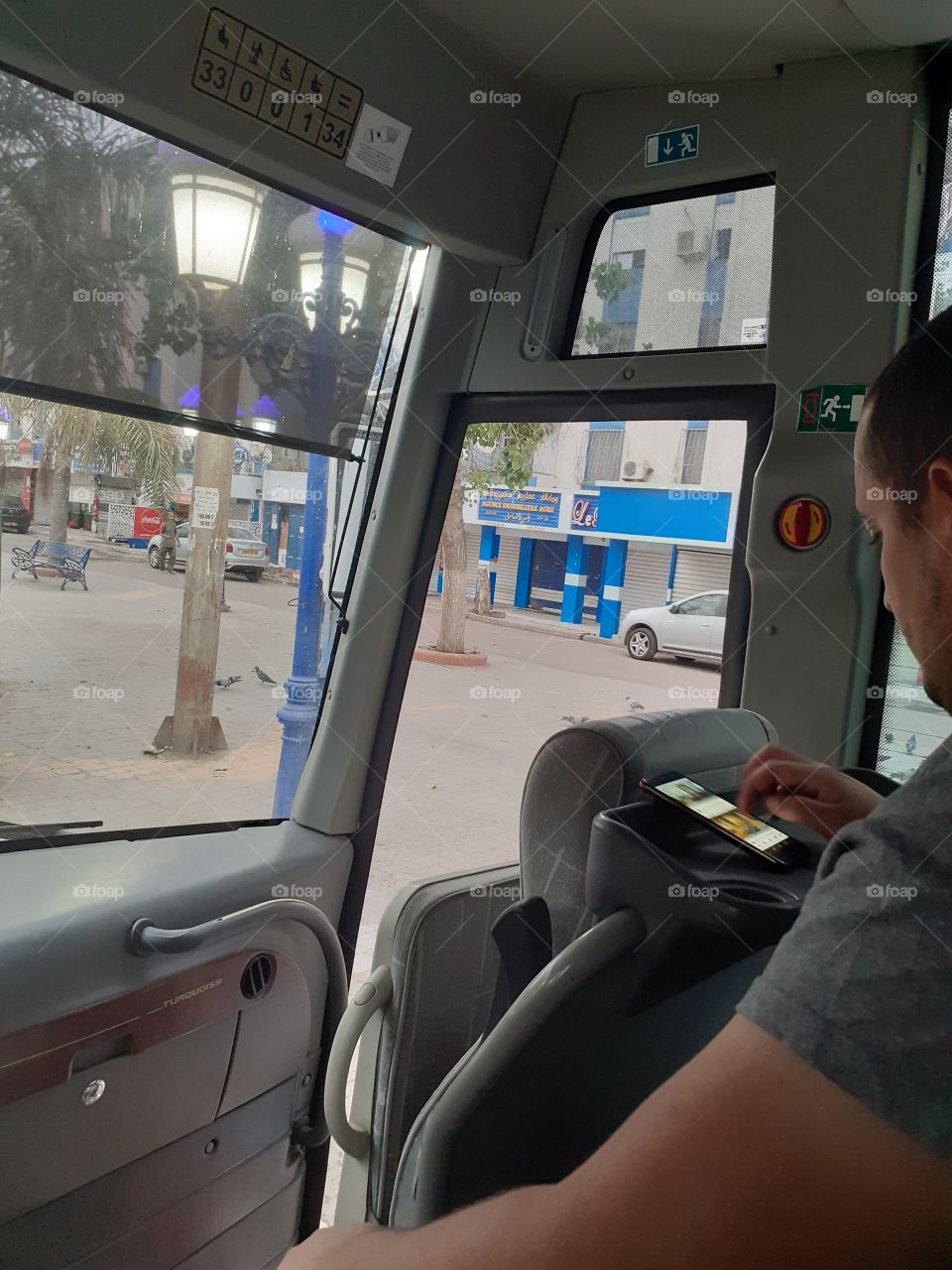 working with cell phone in bus