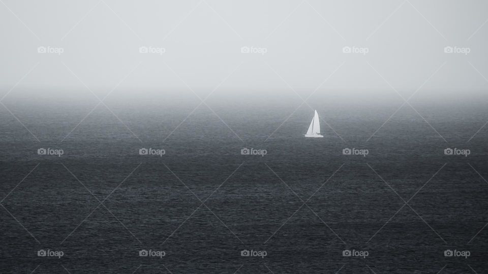 Black and white sailboat in the ocean