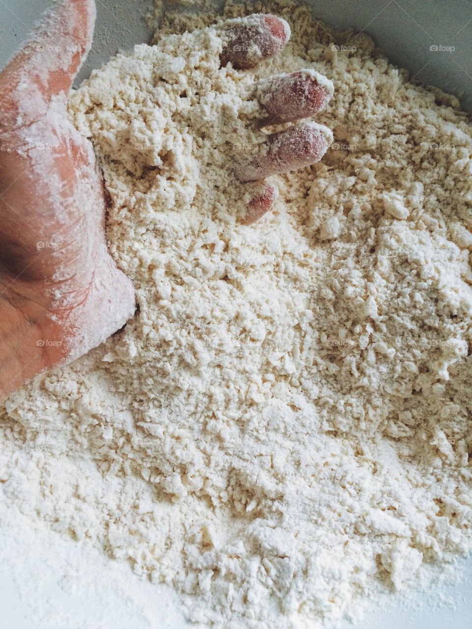 Close-up of hands with flour