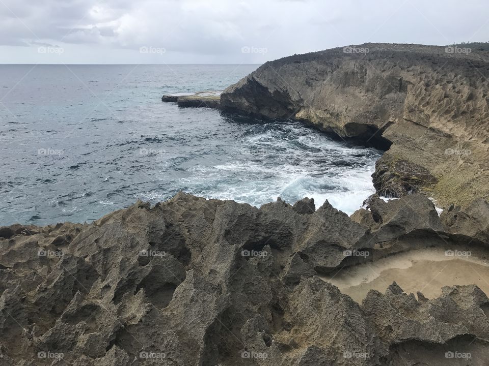 A climb up a sharp, rocky cliff over the ocean