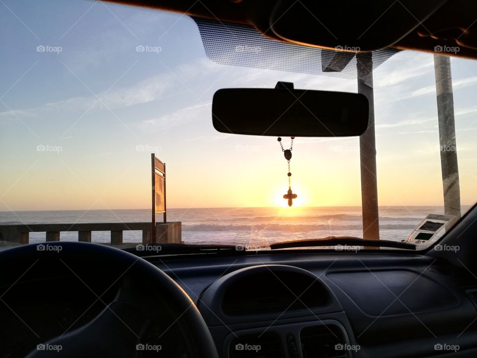 Sunset in car with cross