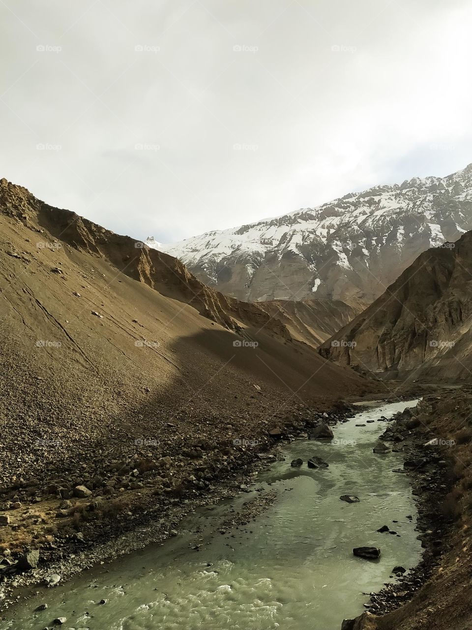 Beautiful river in the snow capped mountains