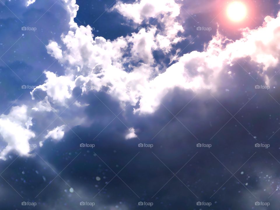 Glowing sun over stormy skies.