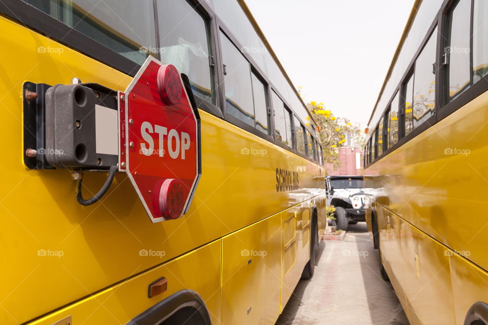 Red Stop sign on a yellow school bus