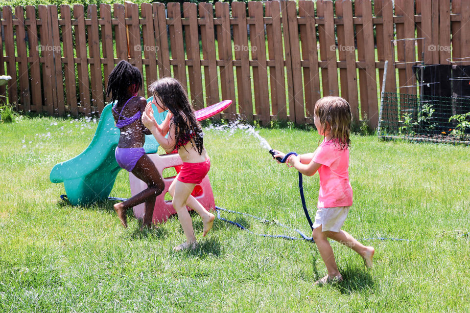 Playing in the water hose 