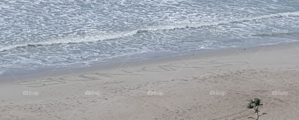 Send Nudes written in sand at the beach