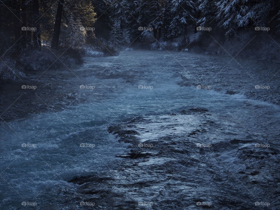 The magnificent Metolius River at Wizard Falls with a morning fog on a cold winter day. 