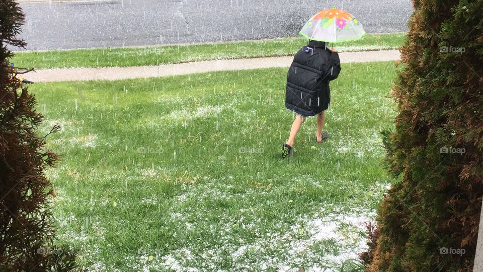 Hail in Utah, in May. A Child playing in it, shorts and flip-flops. 