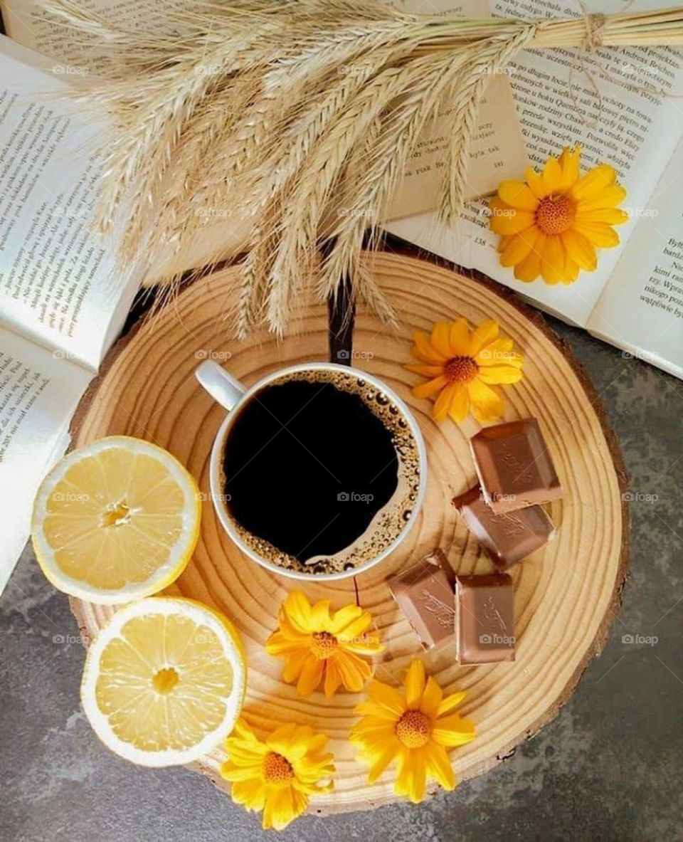 Serve a cup of coffee with flowers and orange slices