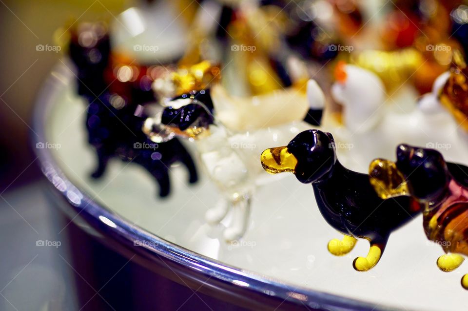 Tiny glass dog figurines on a Table