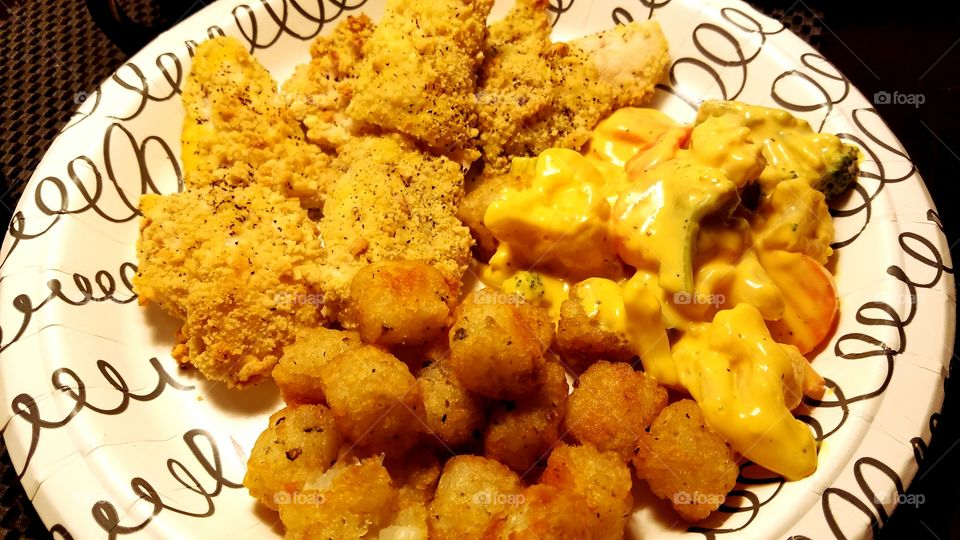 Homemade chicken tenders with tater tots and cheesy veggies