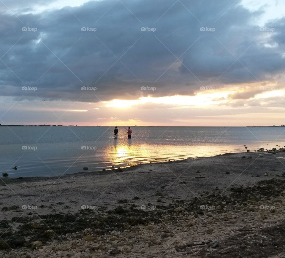 fishing at sunset