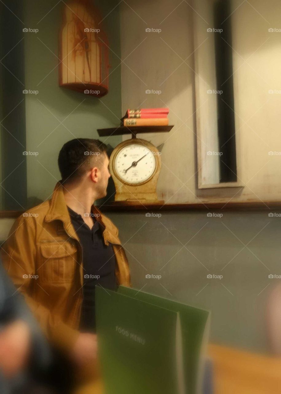 Man in a restaurant with strange objects