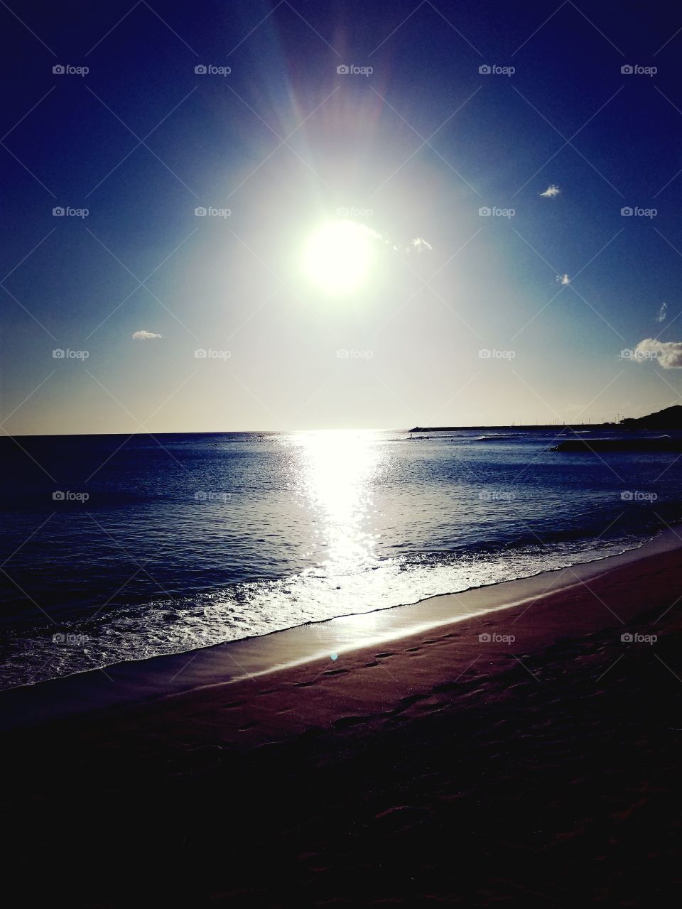 Evening sun lights up the shoreline at Pokai Bay
