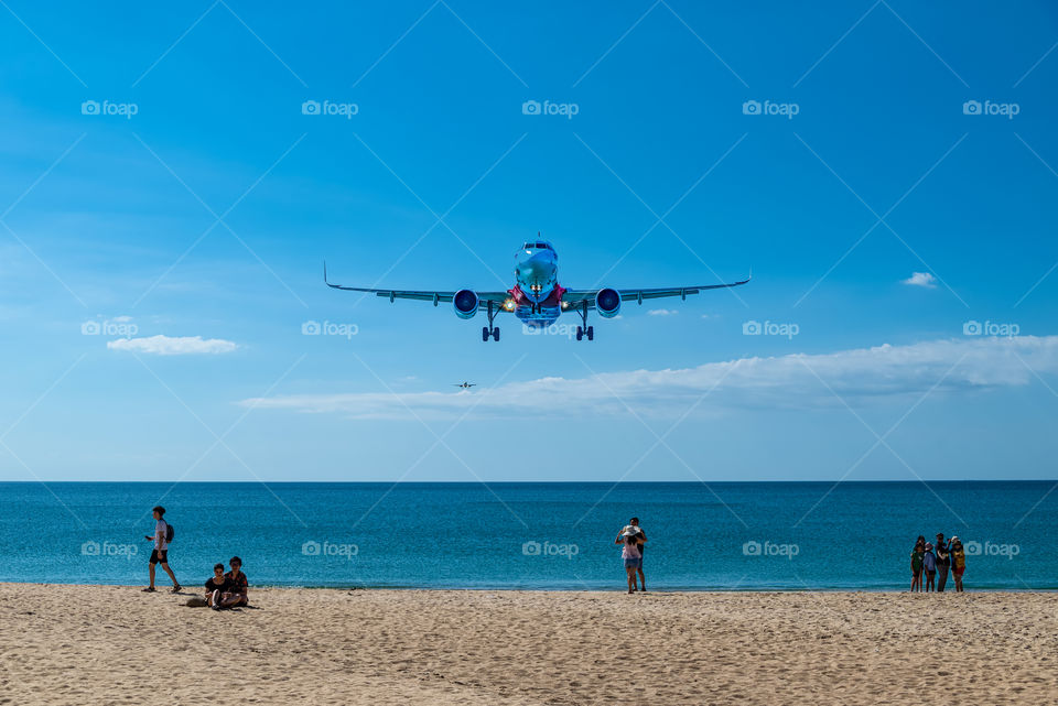 Airplane landing into port at the Beautiful sea scape view in the southern of Thailand