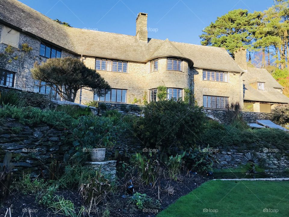Rear of Colleton Fishacre and gardens in winter sunshine,