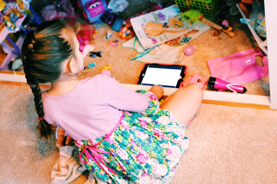 Kid playing her iPad 