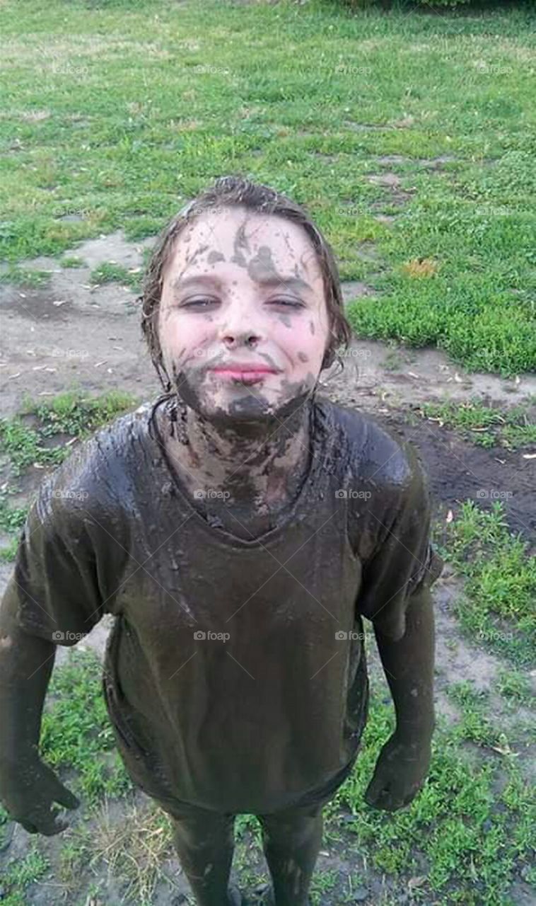 little girl covered in mud