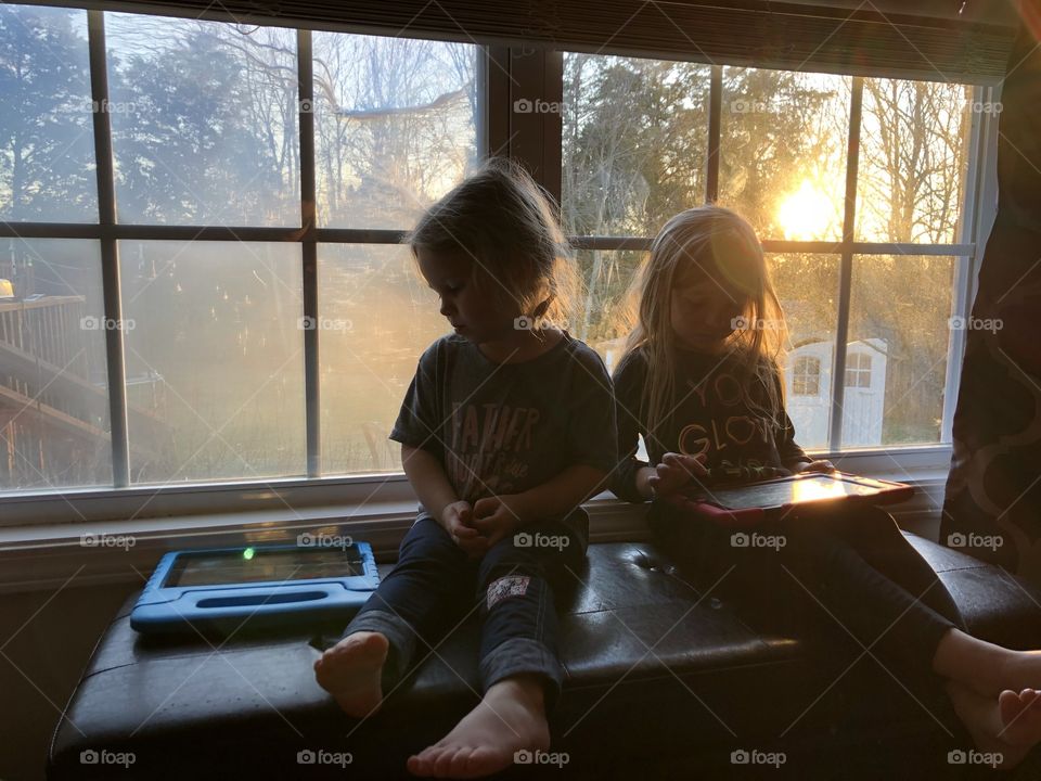 Kids on iPad with a pretty sunset