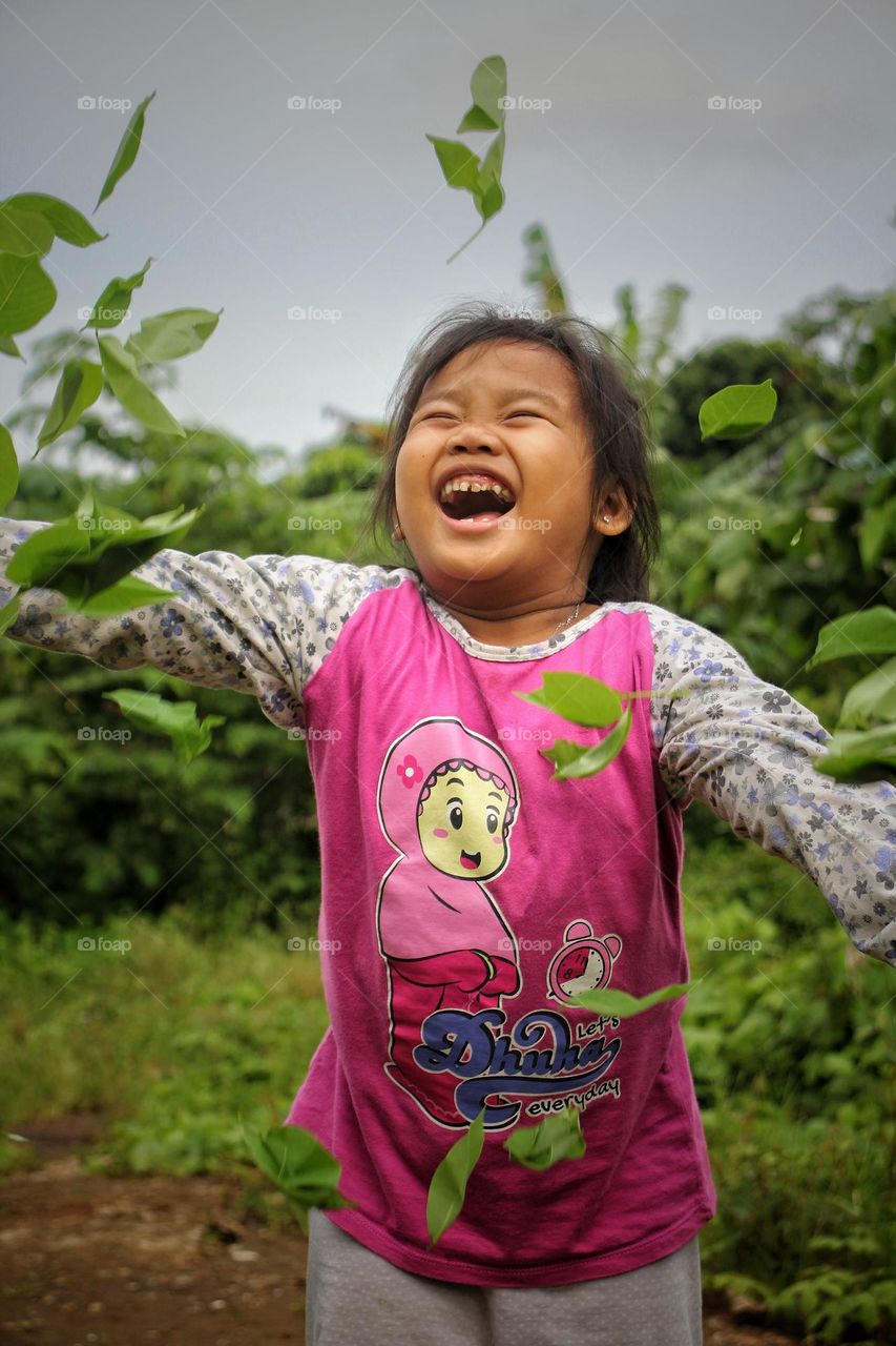 photo of girls having fun playing leaves.