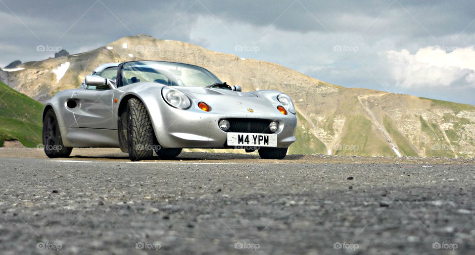 Lotus Elise on the highest mountain pass in France, Col de la Bonette, moody sky before a thunderstorm