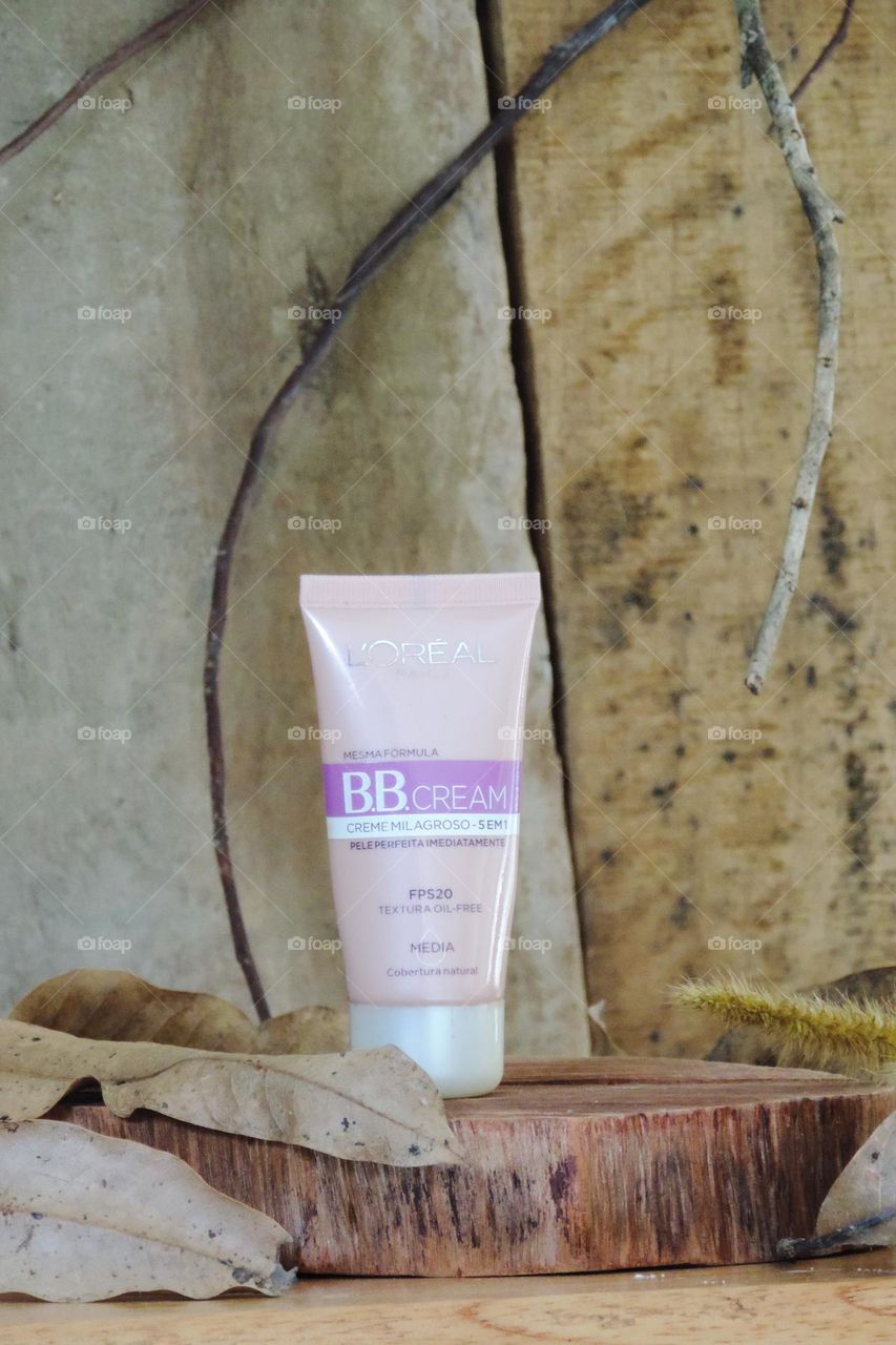 The softness and renewal of the product highlighted on a wooden background and dry leaves.