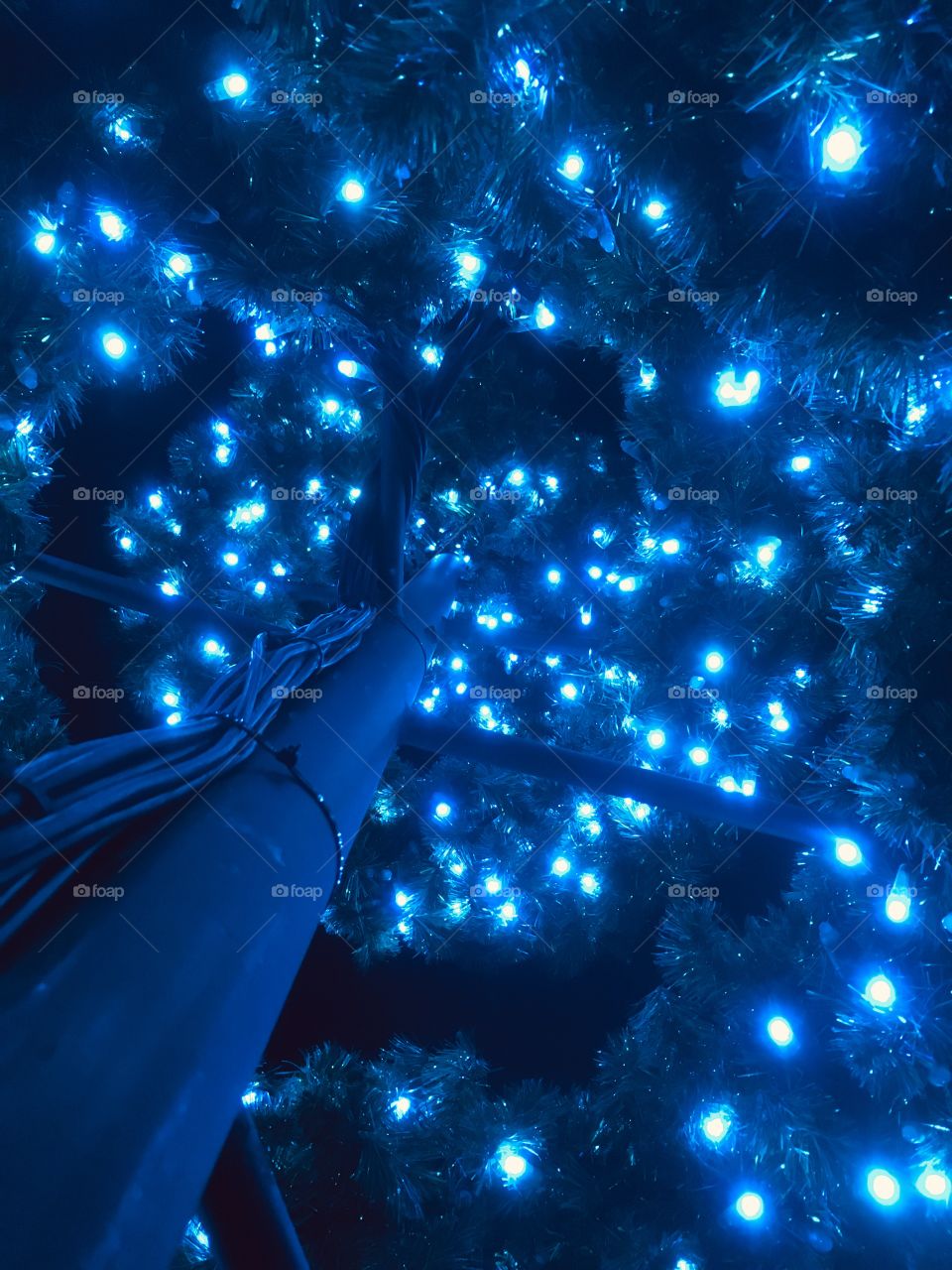 Spiraling blue Christmas lights from underneath 🎄