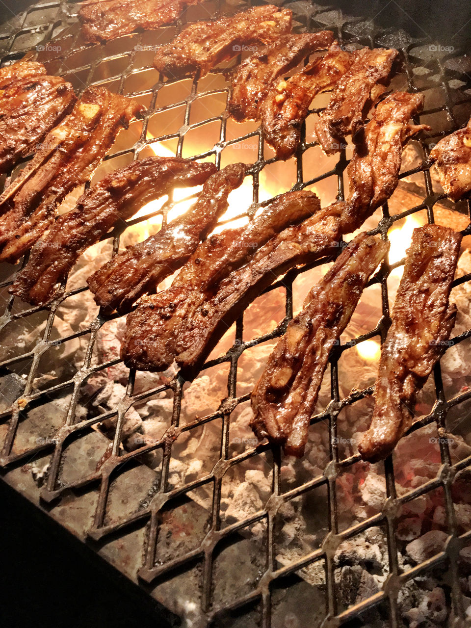 Directly above view of meat on barbecue grill
