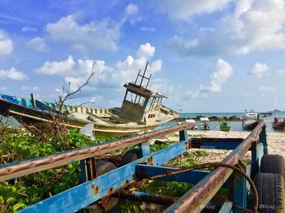 Wooden abandoned boat near the beach