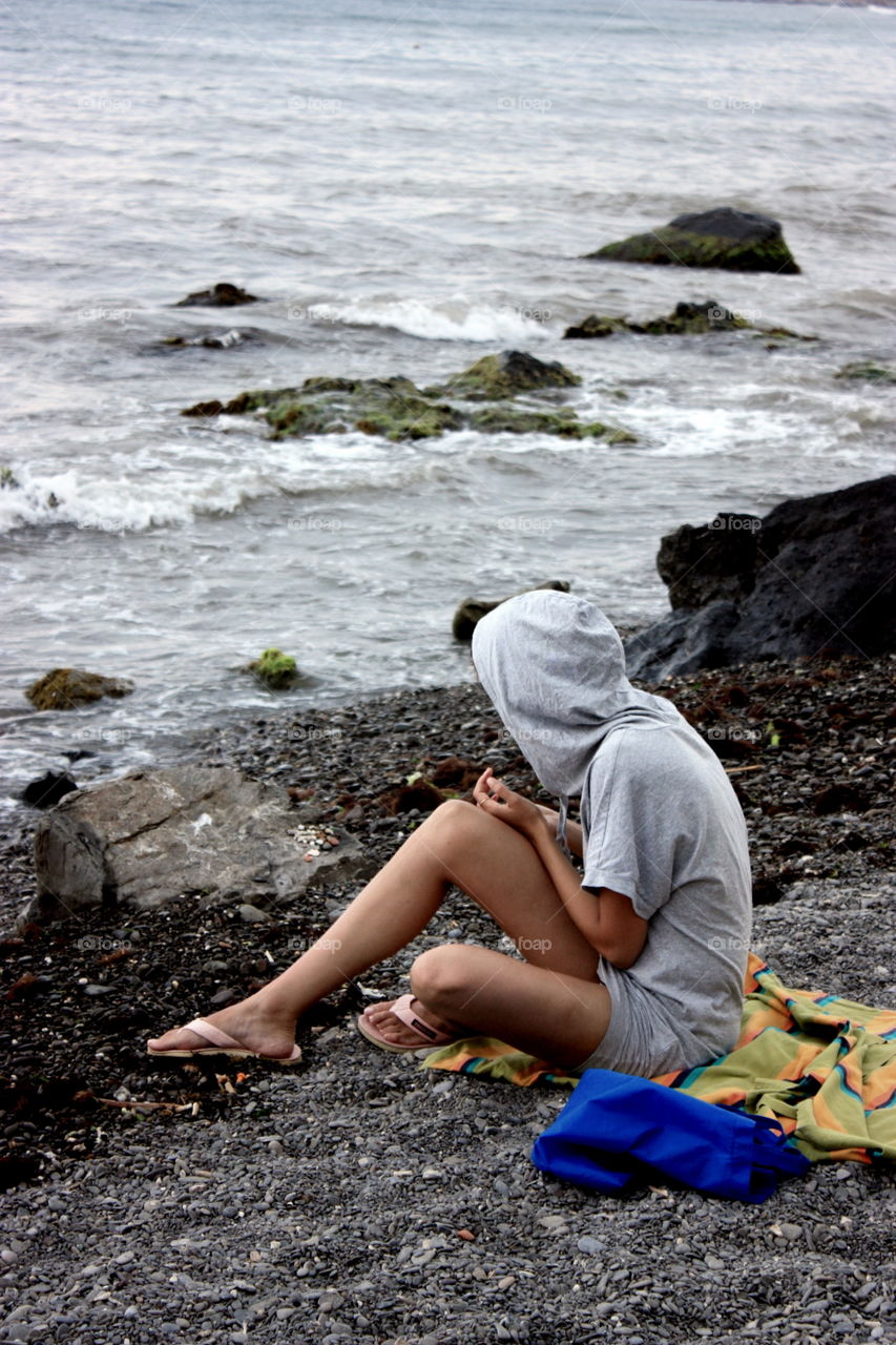 Girl alone at the cold seaside