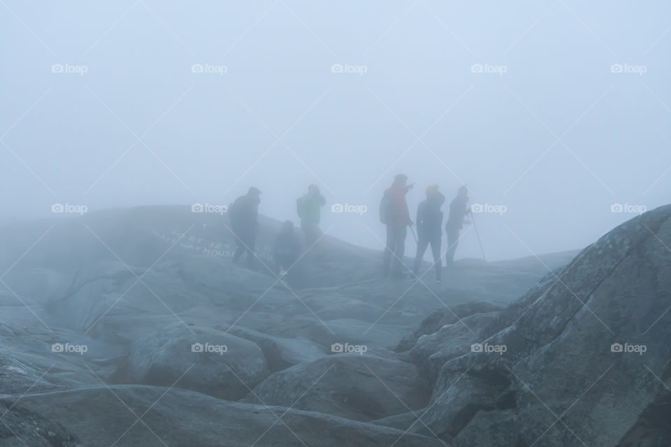 At the Summit of Mount Monadnock, NH during the start of Autumn. It was a cold, rainy, and extremely windy day at the very peak of this mountain. The world’s second most hiked mountain. The fog was so thick, it was hard to see at such close distance.
