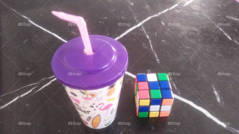 Cube game and cup of juice.