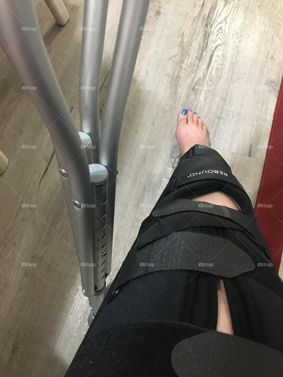 Mid aged lady with braced leg and crutches 