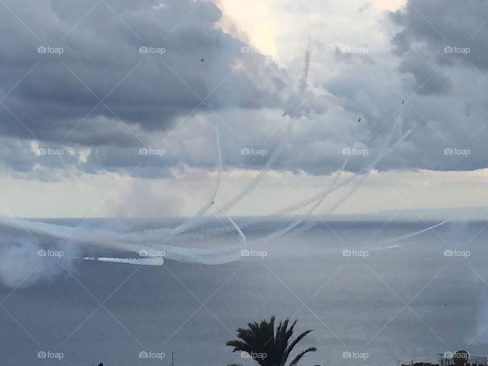 airshow of jet planes over beautiful toarmina in sicily on a cloudy day