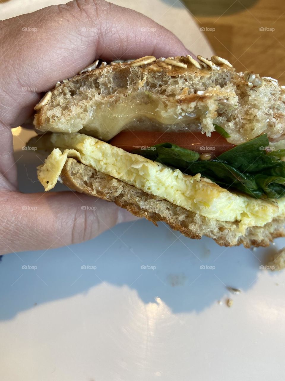 A scrambled egg and cheese with spinach and tomato on a sprouted grain bagel flat that I enjoyed at a local Panera Bread. I love Panera because I can customize my breakfast sandwich to add some vegetables to my morning meal.