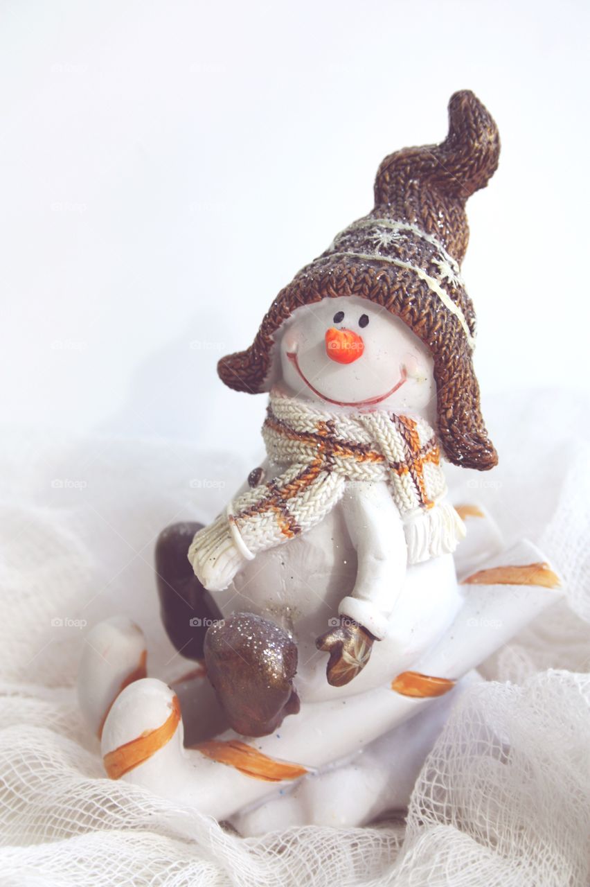snowman in winter sledding