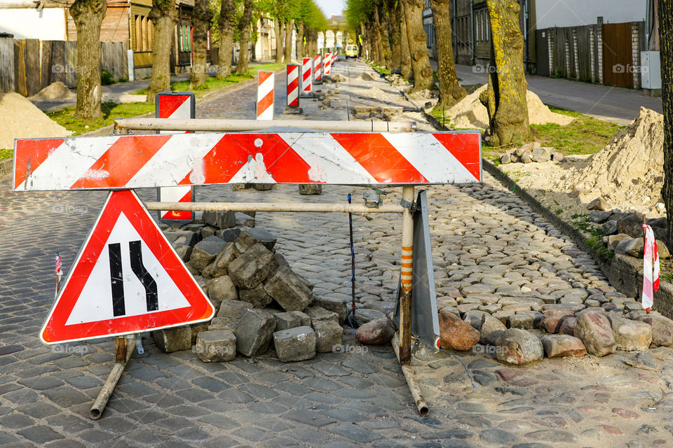 granite cobblestone pavement repair in city street, fragment of destroyed pavement