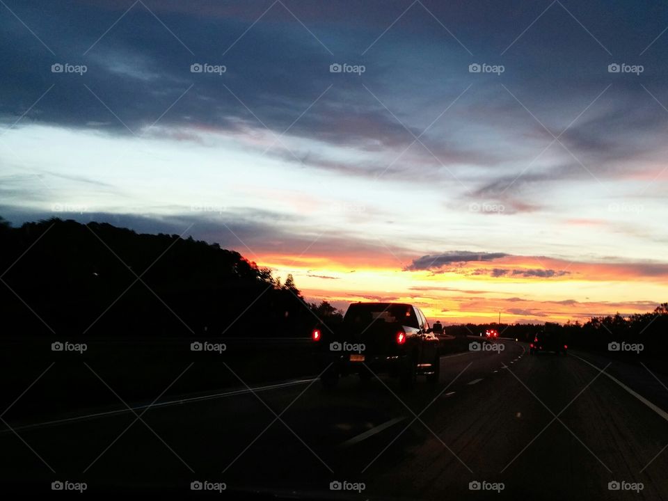 Sunset on the Highway. Truck driving on highway during beautiful Florida sunset