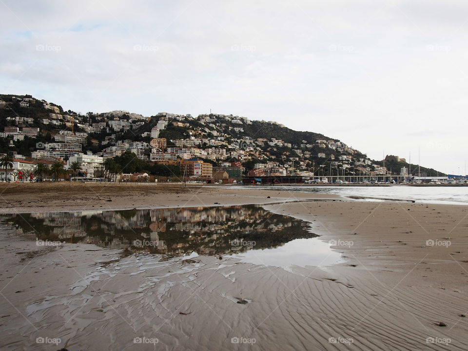 Reflection of town in puddle