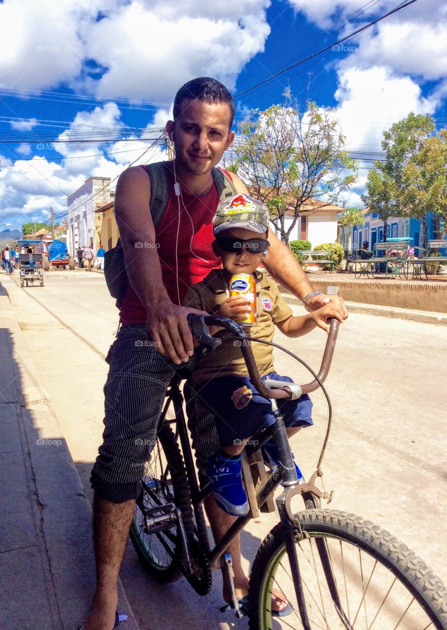 Dad taking his son for a bike ride in Havana, Cuba